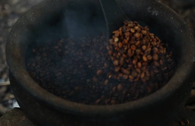 Traditional coffee roasting over fire during Coffee Safari Experience in Tanzania
